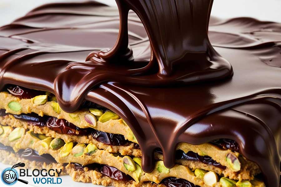date pistachio kunafah layers being covered with chocolate image presented by bloggy world