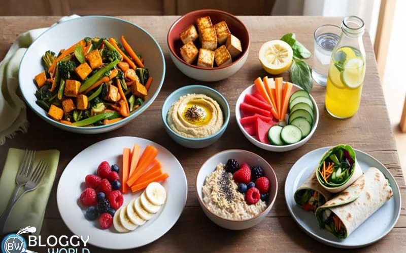 kitchen table with a colorful layout of healthy diet foods — include a bowl of mixed vegetable stir-fry, grilled tofu, a plate of hummus with carrot and cucumber sticks, fresh fruit salad, a bowl of oatmeal topped with banana and flaxseeds, a bottle of infused lemon water, and a whole grain wrap filled with lean protein and greens.